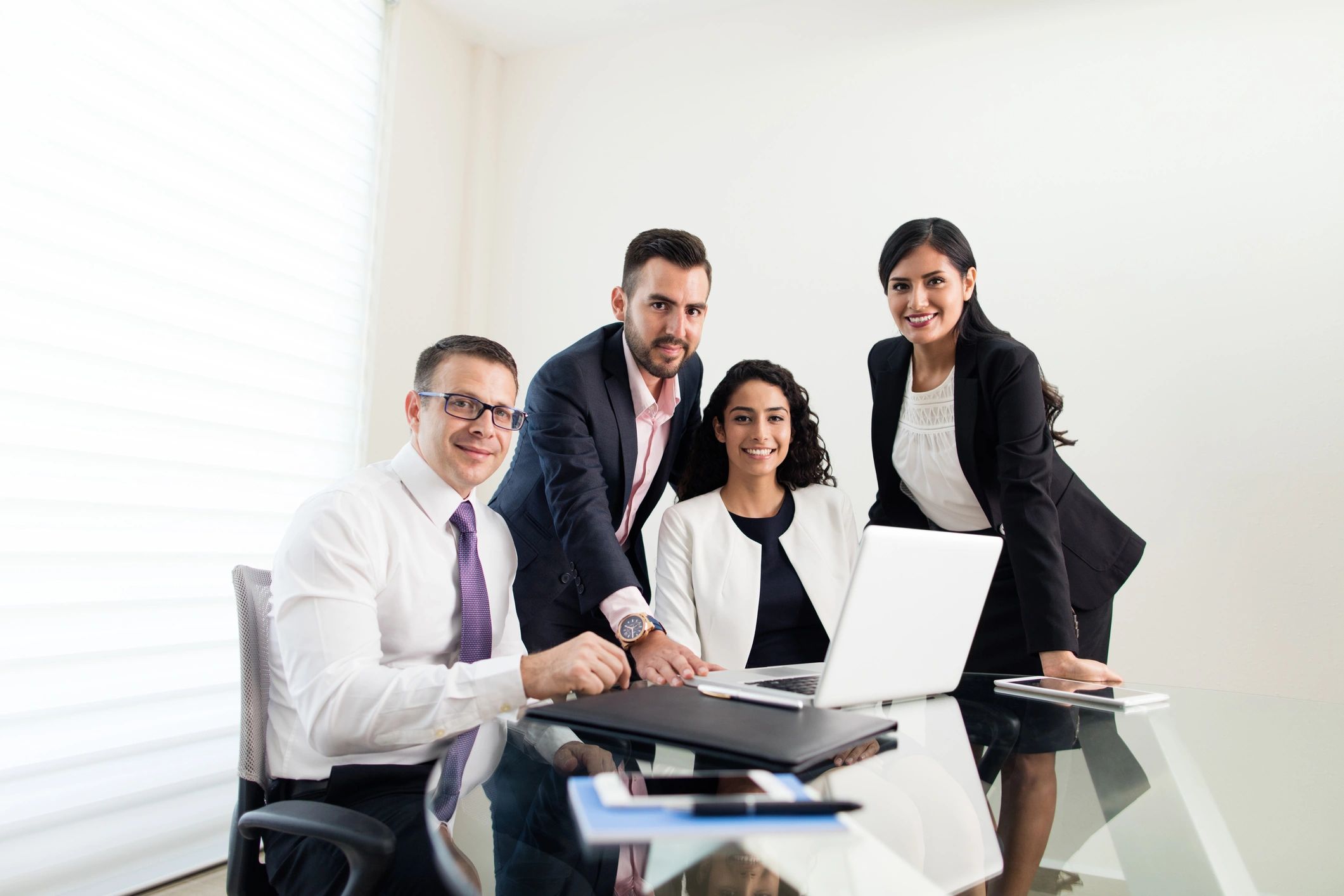 Business executives working together with a laptop