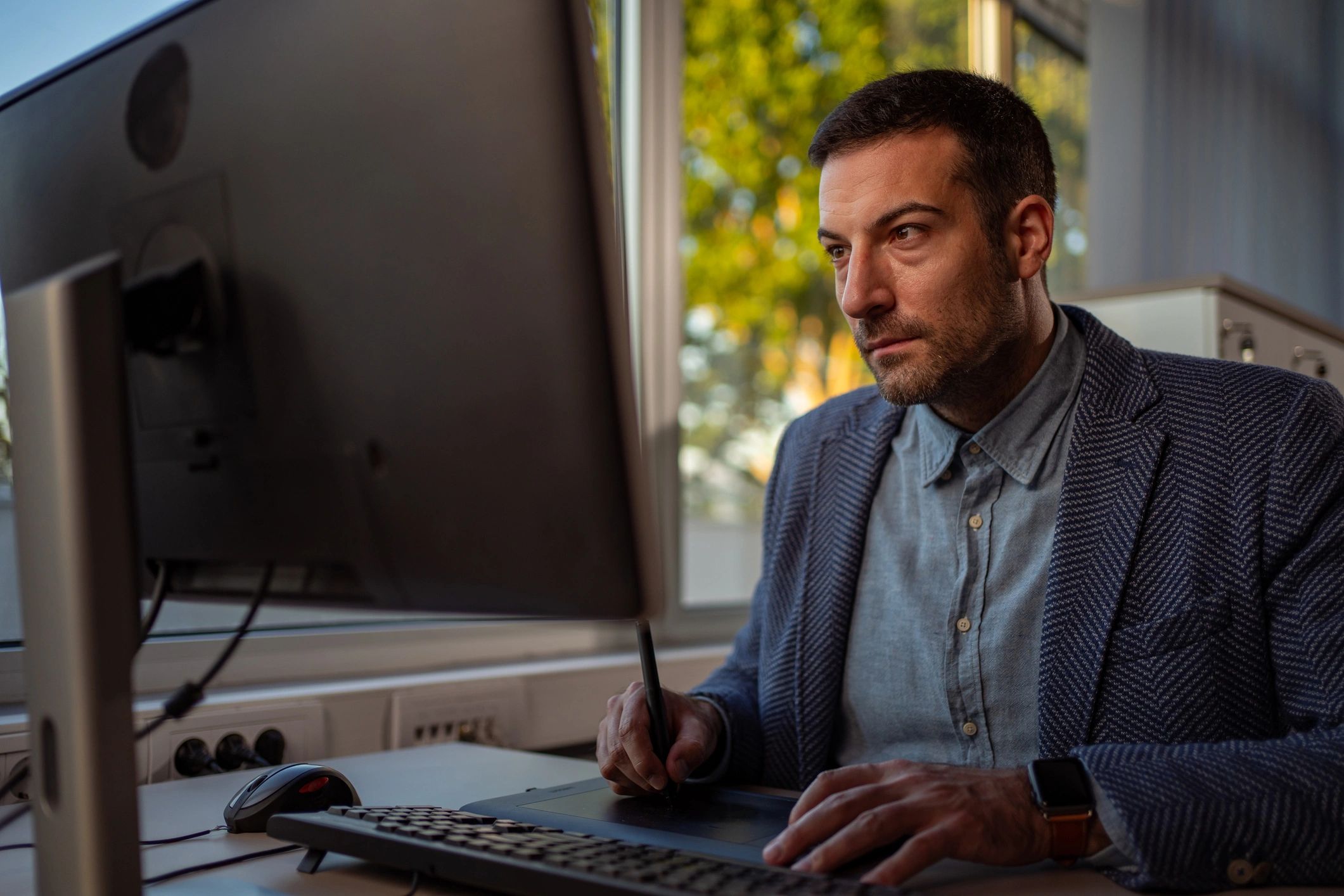 Graphic designer creating marketing materials at a workstation
