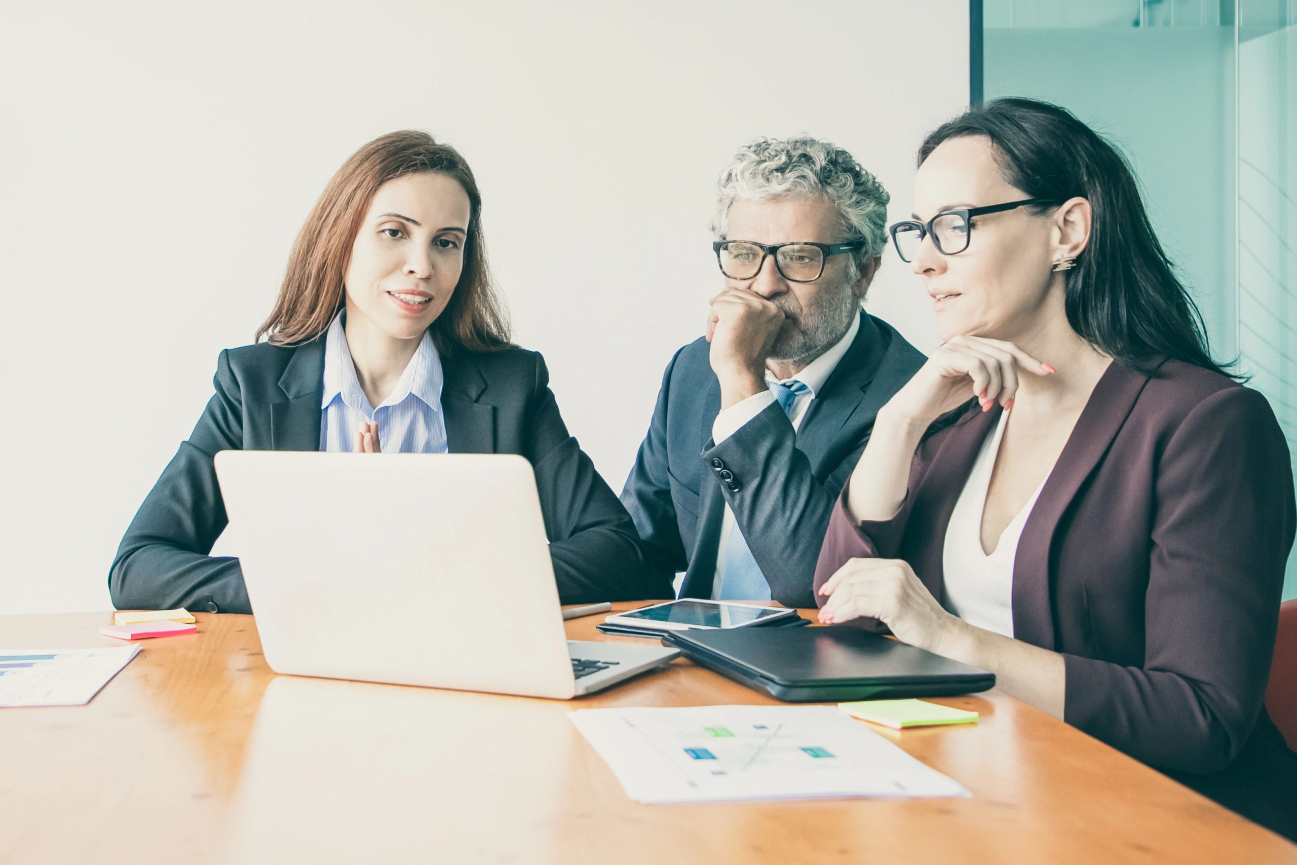 Professionals reviewing CRM presentation on a computer