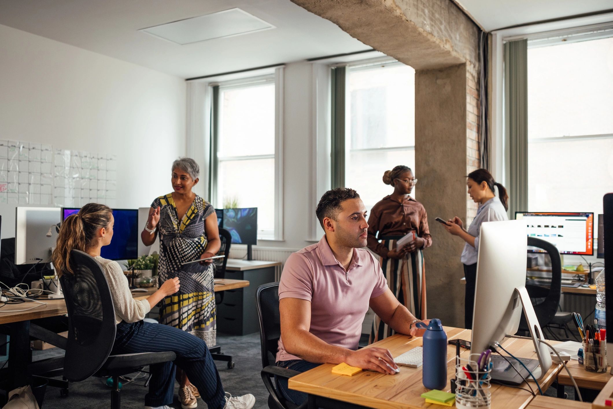 Professional team collaborating in a technology-focused office
