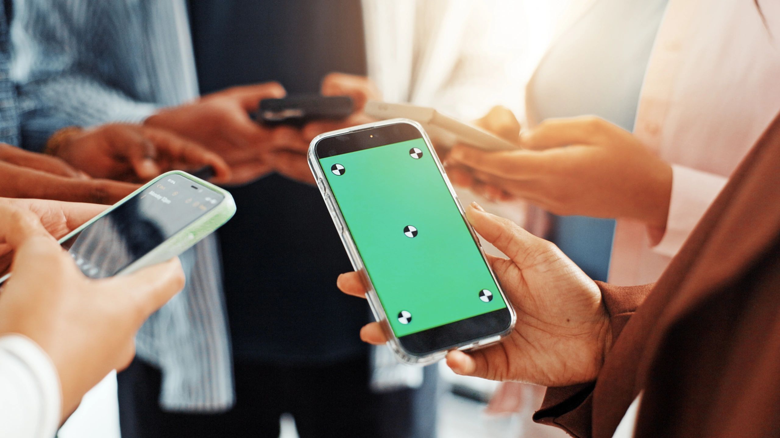 Team using smartphone and social media tools for business marketing