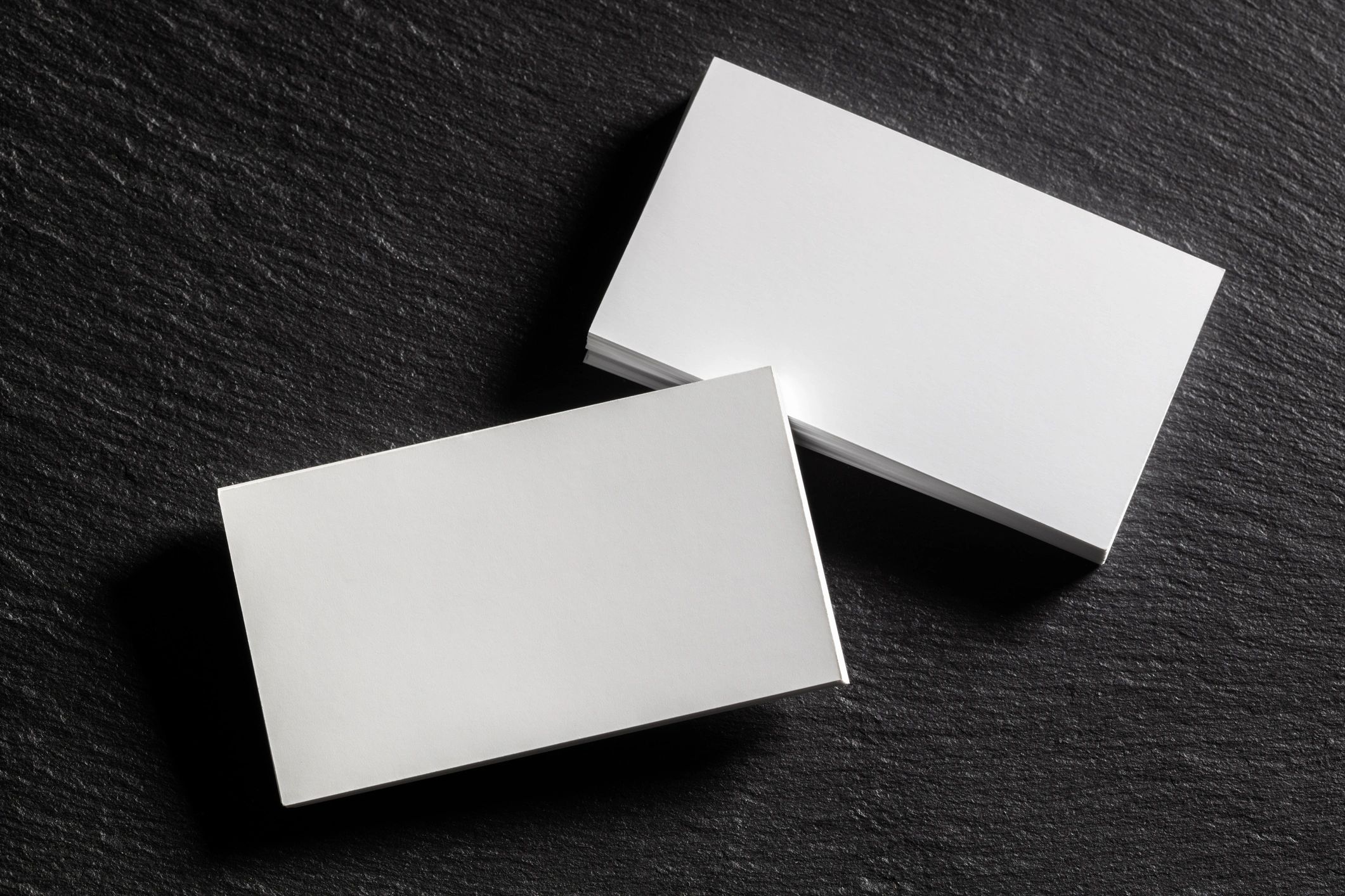 Brand identity mockup with business cards on dark background
