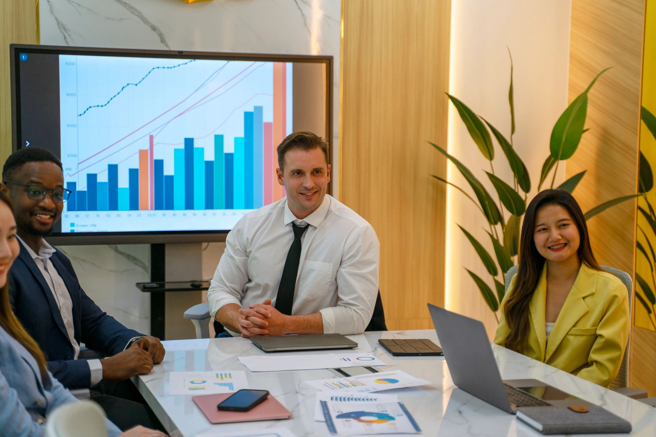 Business team meeting around a laptop in a conference room