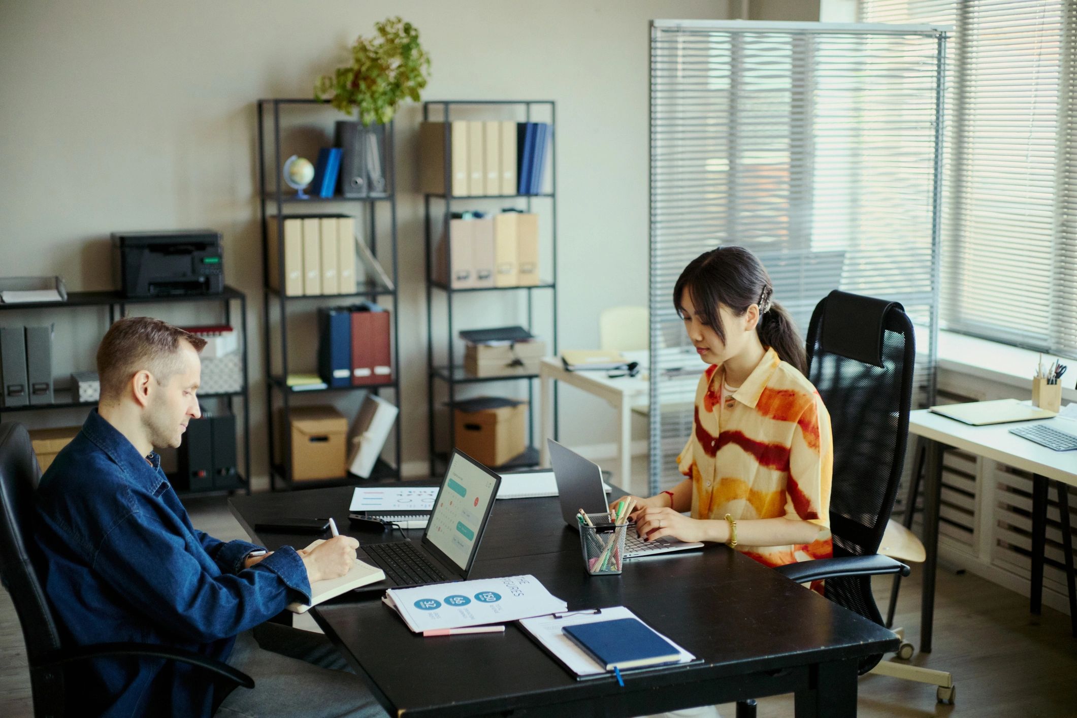 Coworkers collaborating at an office desk
